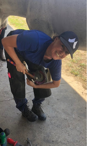 Sarah smiling while fitting a shoe